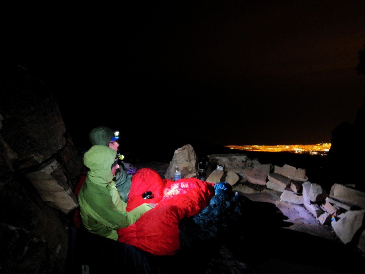 Pat and Josh looking out onto the encroaching city from their bivy below The Rainbow Wall.